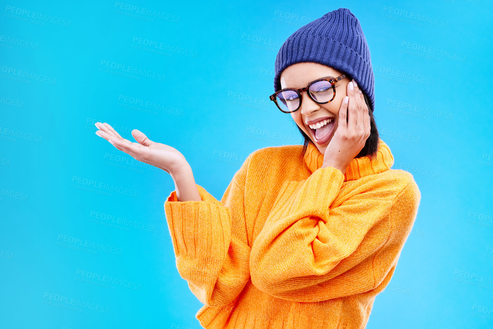 Buy stock photo Woman palm, happiness and portrait in a studio with promotion and announcement. Excited, isolated and blue background with mockup of a gen z girl and cool young female show marketing with smile