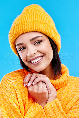Happiness, excited portrait and woman with mockup in studio ready for cold weather with winter hat. Isolated, blue background and mock up with a happy young and gen z person with a smile and beanie