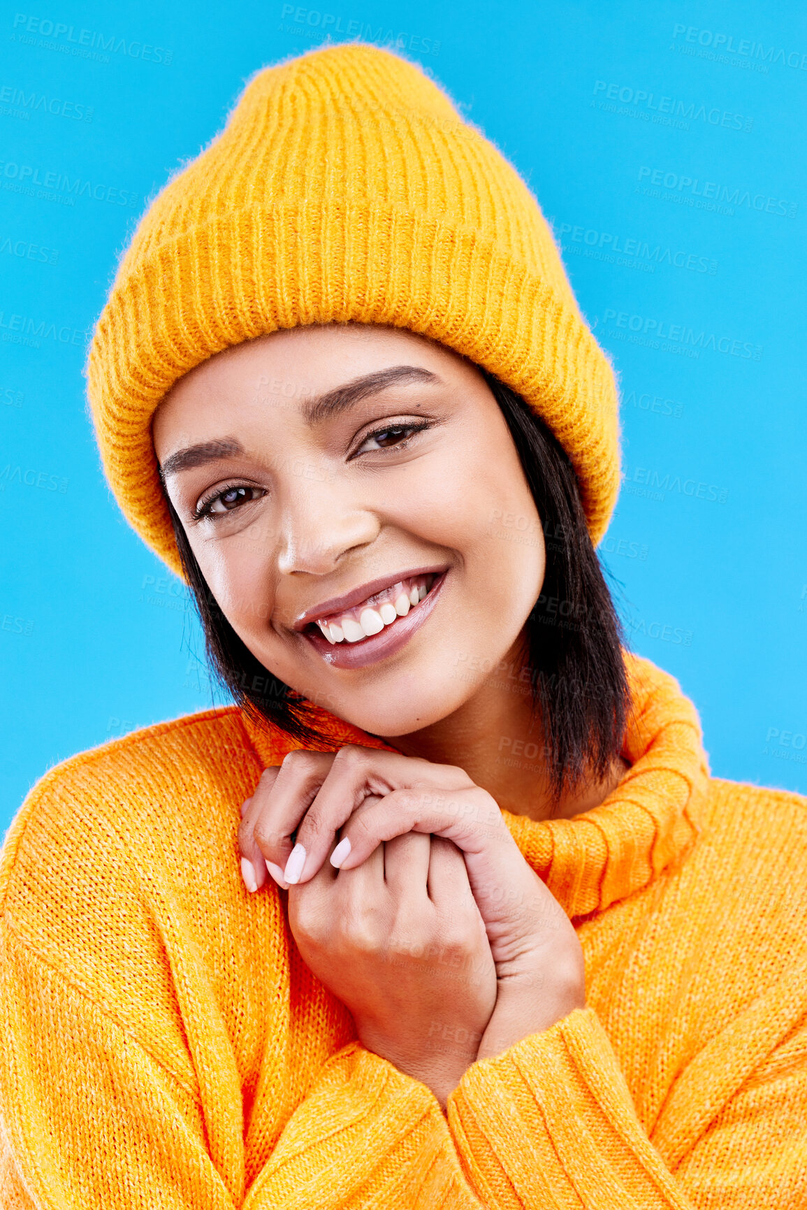 Buy stock photo Happiness, excited portrait and woman with mockup in studio ready for cold weather with winter hat. Isolated, blue background and mock up with a happy young and gen z person with a smile and beanie