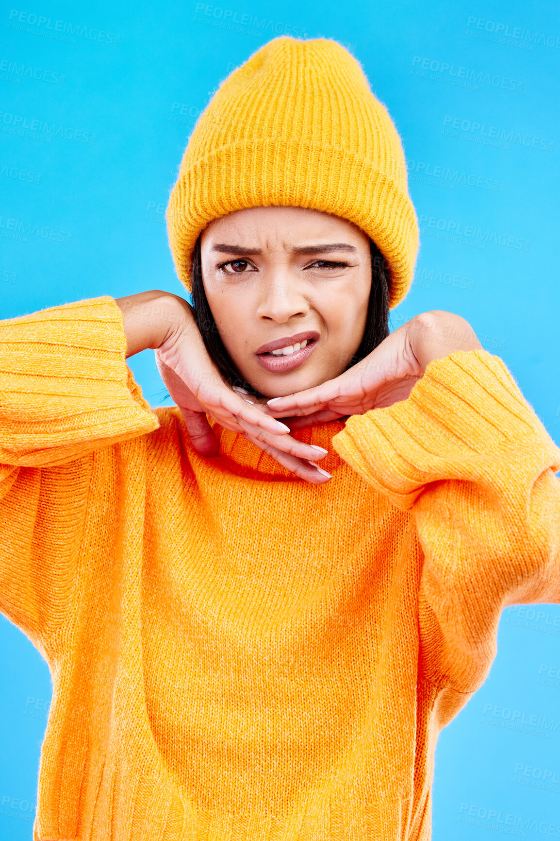 Buy stock photo Portrait of woman in winter fashion with confused face, beanie and doubt isolated on blue background. Style, expression and attitude, gen z girl on studio backdrop with warm clothing for cold weather