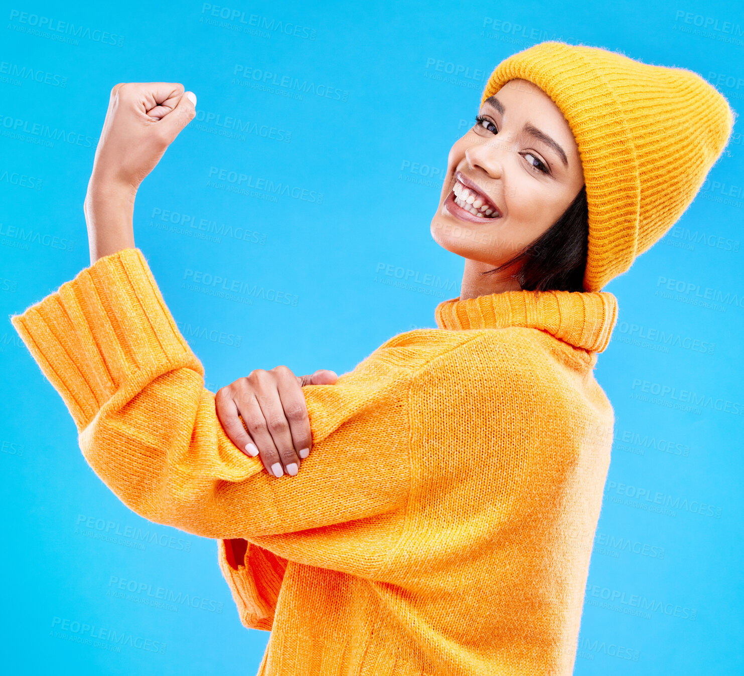 Buy stock photo Happy, arm and portrait of a woman with muscle isolated on a blue background in a studio. Smile, strong and a girl showing muscles, power and motivation for exercise on a backdrop for confidence