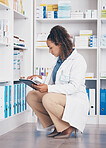 Tablet, stock and health with a pharmacist woman at work to fill an online order or prescription. Healthcare, product and insurance with a female working as a medicine professional in a pharmacy