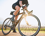 Bicycle, ride outdoor and person on a bike with travel for sports race on a vineyard gravel road. Fitness, exercise and fast athlete doing sport training in nature on a trail for cardio and workout