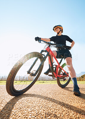 Buy stock photo Bicycle break, ride and woman on a bike from below for sports race on a gravel road. Fitness, exercise and athlete doing sport training in nature or countryside for cardio rest and healthy workout