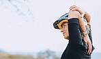 Sports, cycling and arm stretch by woman outdoors for training, exercise and warm up. Start, stretching and female cyclist prepare for fitness, cardio and routine in the countryside, calm and content