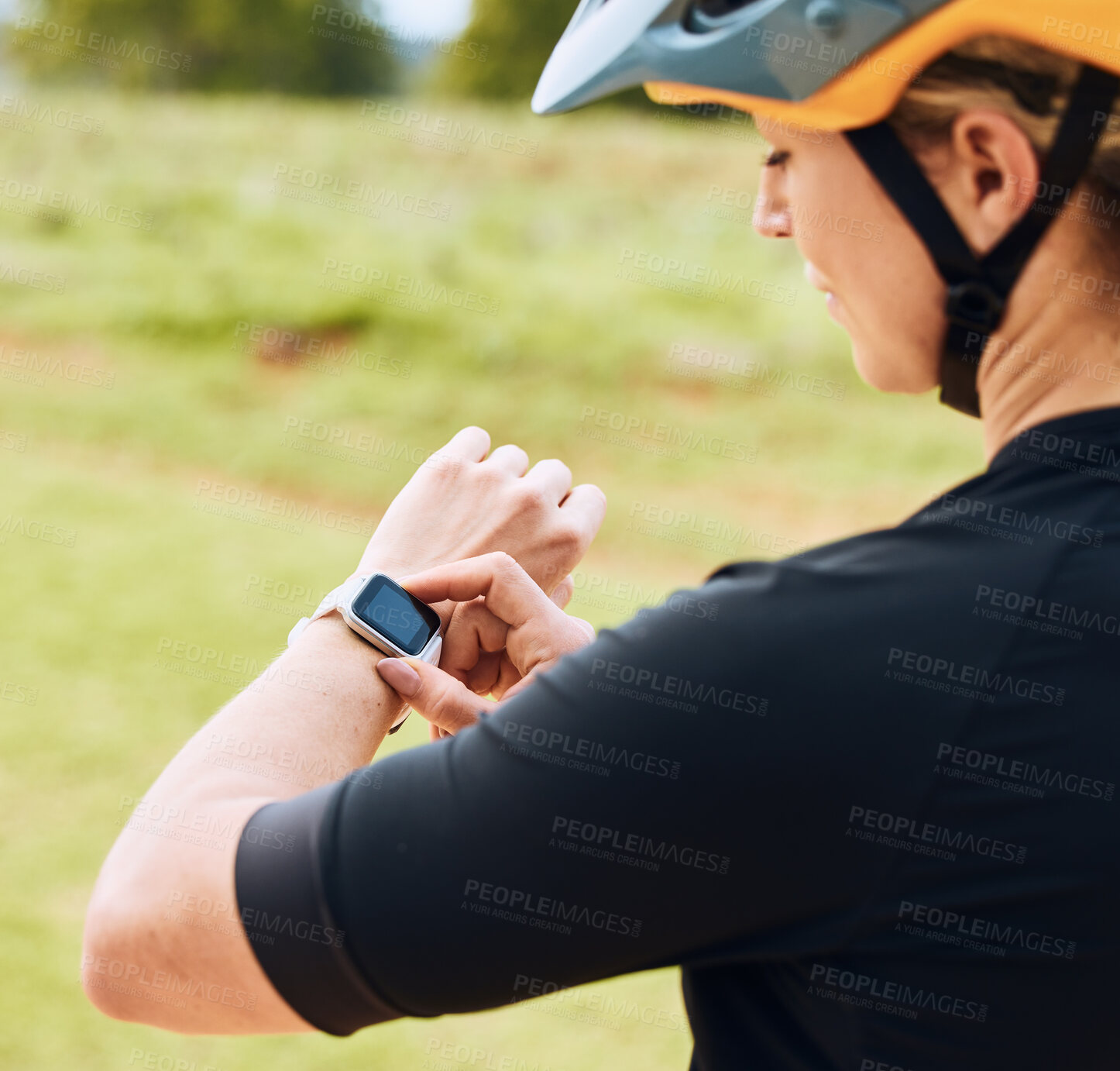 Buy stock photo Smartwatch, heart rate and woman cyclist outdoor checking pulse for bike and cycling fitness. Exercise, wellness app and female athlete doing a time check for bicycle race in nature by grass