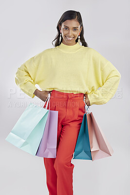 Buy stock photo Portrait, shopping and sale with a woman customer in studio on a gray background for retail or consumerism.  Fashion, luxury or bags with a female consumer or shopper standing hands on hips for deals