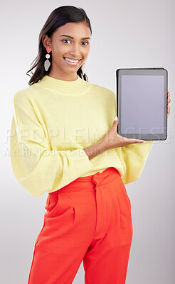 Buy stock photo Tablet, mockup and portrait of woman isolated on a white background for fashion e commerce, sale or promotion space. Happy indian person or model with gen z clothes on digital tech mock up in studio
