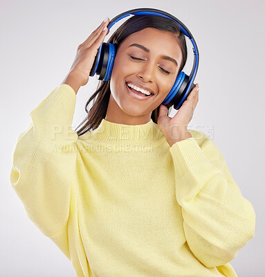 Buy stock photo Woman with headphones, listening to music and happy on studio background with freedom, fun and peace. Smile, carefree and technology with entertainment, Indian female and radio streaming  playlist