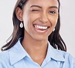 Wink, dental and woman with teeth whitening for oral or mouth hygiene isolated in a white studio background. Smile, tongue and portrait of an Indian female or businesswoman with a perfect smile