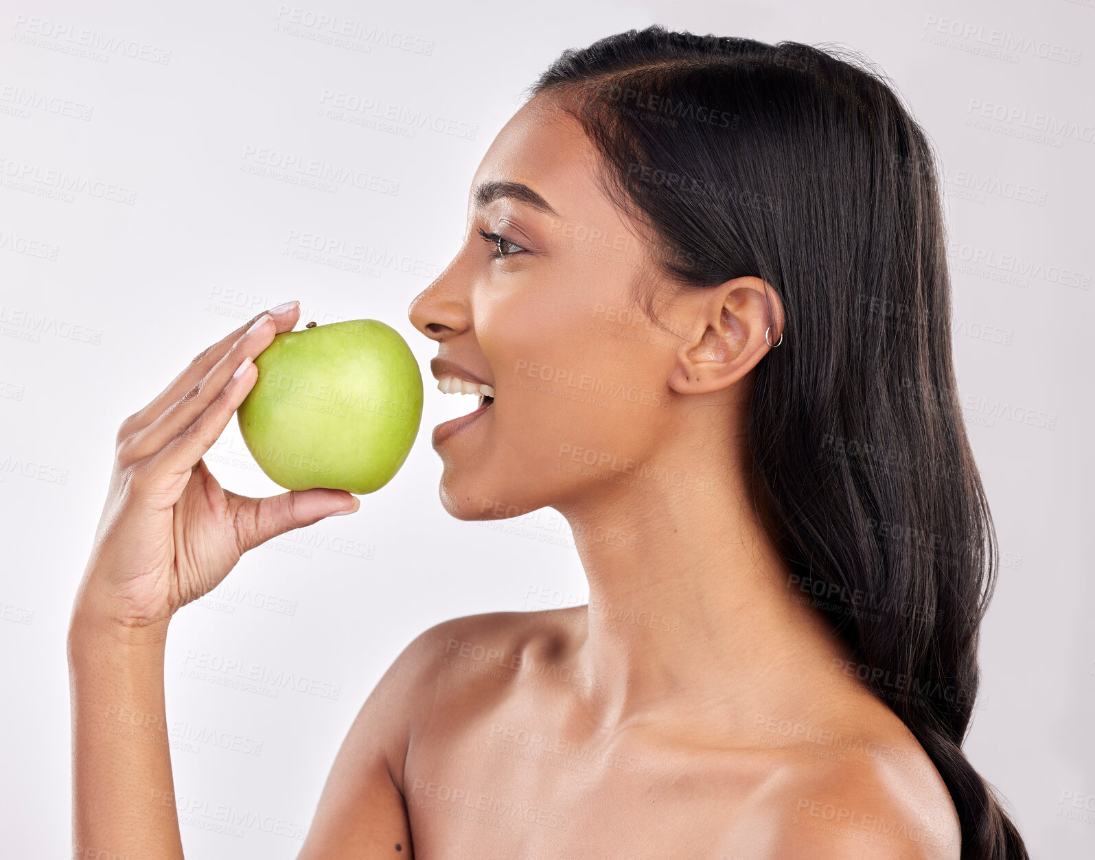 Buy stock photo Woman, apple and face profile, health nutrition and fruit with healthy food and detox diet on studio background. Weight loss, organic and fresh produce with happy female mouth, wellness and lifestyle