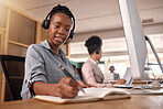 Call center, woman and writing at computer on desk in office for sales and customer service notes or information, African female agent or consultant in telemarketing, support and crm with pen