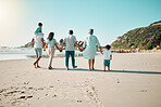 Family, walking and holding hands outdoor on a beach with children, parents and grandparents together. Men, women and boy kids walk at sea with love, care and quality time for summer travel vacation