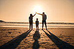 Family silhouette at the beach during sunrise, people with safety and security, parents protect child while outdoor. Mother, father and kid in nature, back and ocean view with love, care and support