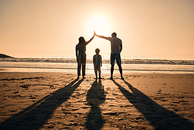 Buy stock photo Family silhouette at beach, protection and sunset with people, safety and security with parents and child outdoor. Mother, father and kid in nature, back and ocean view with love, care and support