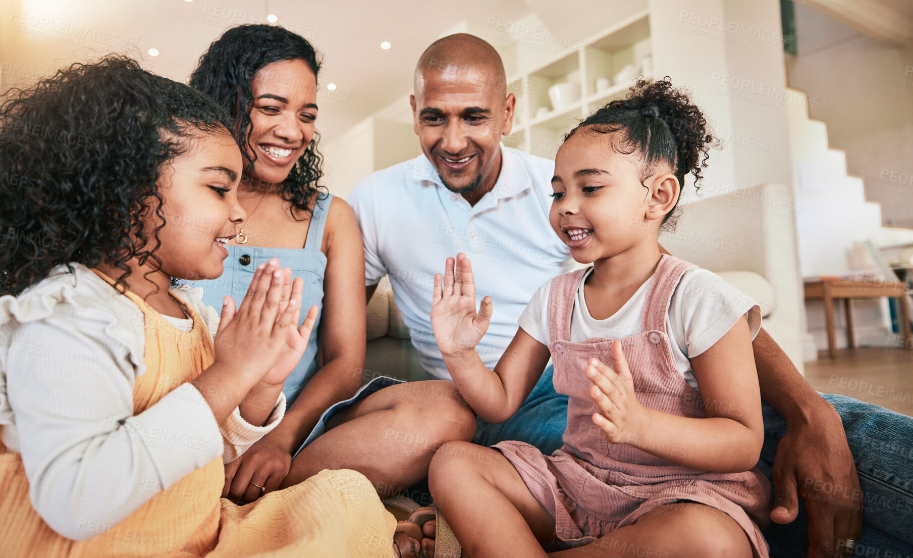 Buy stock photo Happy family, hands and game by children playing, smile and having fun in a living room. Games, kids and parents bonding in their home, cheerful and relaxing indoors, smiling and enjoying childhood