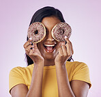 Donut, dessert and cover with woman in studio for diet, snack and happiness. Sugar, food and smile with female hiding and isolated on pink background for nutrition, playful and craving mockup