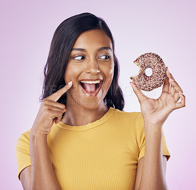 Buy stock photo Donut, dessert and bite with woman in studio for diet, snack and happiness. Sugar, food and smile with female eating sweets treat isolated on pink background for nutrition, excited and craving mockup