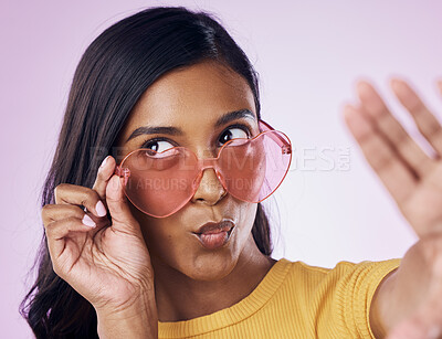Buy stock photo Selfie, heart and sunglasses by indian woman in studio emoji, cool and fun on purple background. Glasses, trendy and female gen z fashion influencer posing for profile picture, photo or blog post