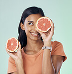 Studio beauty, face and happy woman with grapefruit for natural skincare, health and wellness routine. Fruit detox, vitamin c benefits and nutritionist person with citrus product on green background