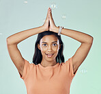 Portrait, yoga and bubbles with a woman meditating in studio on a gray background for zen or namaste. Fitness, health and wellness with an attractive young female yogi practicing meditation for peace