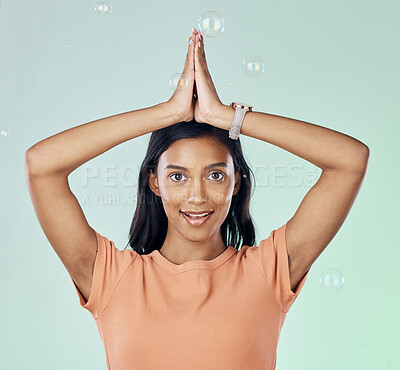 Buy stock photo Portrait, yoga and bubbles with a woman meditating in studio on a gray background for zen or namaste. Fitness, health and wellness with an attractive young female yogi practicing meditation for peace