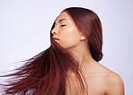 Hair care flip, woman and portrait in a studio with beauty and haircut growth from salon styling. Isolated, gray background and young female model with healthy cosmetics and shampoo treatment results