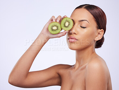 Buy stock photo Beauty, skincare and kiwi with woman in studio for natural cosmetics, diet and nutrition. Product, glow and self care with female model and fruit on white background for spa, food and vitamin