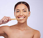 Portrait, dental or happy girl brushing teeth with smile for healthy oral hygiene in studio white background. Beauty or Brazilian woman model cleaning mouth with a natural bamboo wooden toothbrush