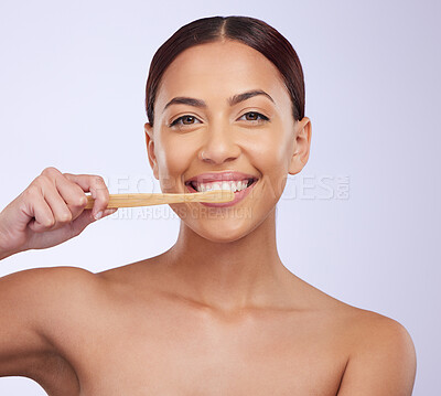 Buy stock photo Portrait, dental or happy girl brushing teeth with smile for healthy oral hygiene in studio white background. Beauty or Brazilian woman model cleaning mouth with a natural bamboo wooden toothbrush