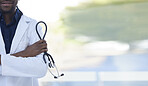 Doctor, man and hands with stethoscope for healthcare insurance, cardiology or checkup against a blurred background. Hand of male medical professional arms crossed in confidence for health at clinic