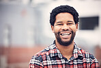 Happy, smile and portrait of black man in city for holiday, vacation and freedom on weekend outdoors. Travel, happiness and face of male with confidence, positive mindset and excited in urban town