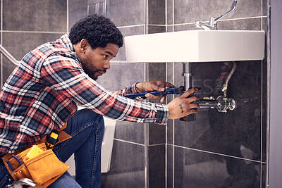 Buy stock photo Black man, plumber and maintenance in bathroom, fixing sink pipe with wrench and plumbing industry. Manual labor, male with focus and trade, handyman doing repairs with tools on home renovation