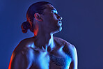 Man, sexy body and light in studio for art, fitness or beauty of a person on a blue background. Face, strong chest and fitness model with a tattoo, glow and creative motivation for aesthetic backdrop