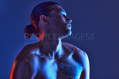 Buy stock photo Man, sexy body and light in studio for art, fitness or beauty of a person on a blue background. Face, strong chest and fitness model with a tattoo, glow and creative motivation for aesthetic backdrop