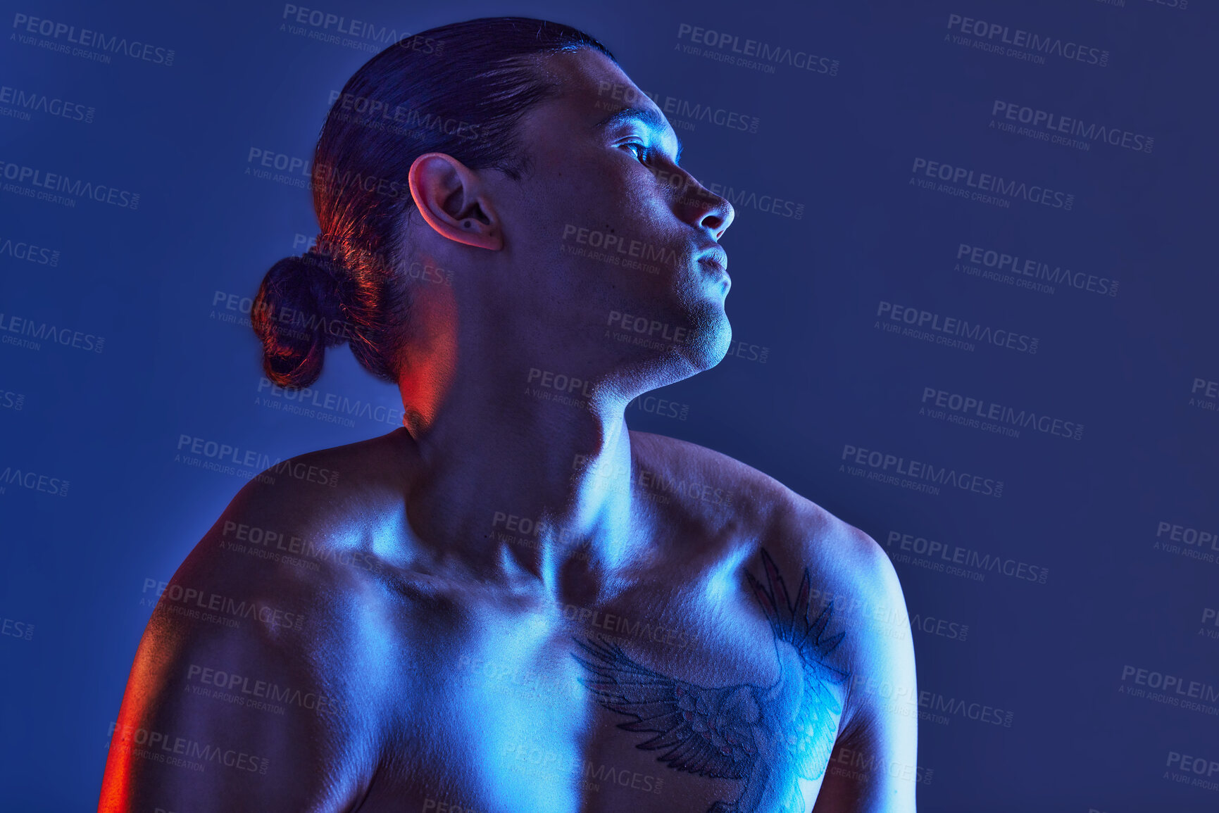 Buy stock photo Man, sexy body and light in studio for art, fitness or beauty of a person on a blue background. Face, strong chest and fitness model with a tattoo, glow and creative motivation for aesthetic backdrop