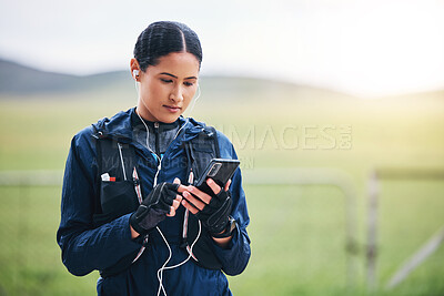 Buy stock photo Music, phone and woman in the countryside ready for fitness and exercise with mockup. Sports, training and mobile headphones of a female athlete looking at gps with audio and web radio for workout