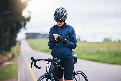 Buy stock photo Woman, bicycle athlete and outdoor with phone for social media technology, mobile app or search gps direction. Female cyclist, bike and typing on smartphone for network notification, sport or cycling