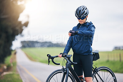 Buy stock photo Cyclist woman, check time and nature on road for speed, gps and heart rate with fitness, health and wellness goal. Cycling, bicycle and female athlete with watch for exercise, training and workout