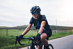 Sports, nature and male athlete cycling on a bicycle training for a race, marathon or competition. Fitness, workout and man cyclist riding bike for cardio exercise on an outdoor road in the mountain.