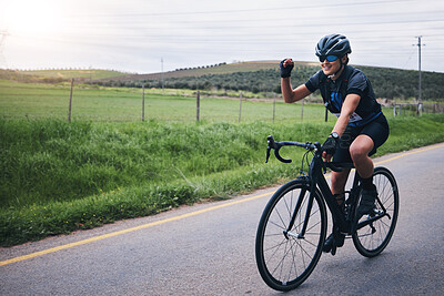 Buy stock photo Fitness, win and woman in celebration while cycling in nature with energy for a race, marathon or competition. Sports, workout and female athlete cyclist cheering for cardio exercise on outdoor road.