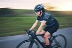 Fast, fitness and cycling with woman in road for training, competition and championship. Workout, sports and triathlon with female cyclist on bike for freedom, exercise and speed with motion blur