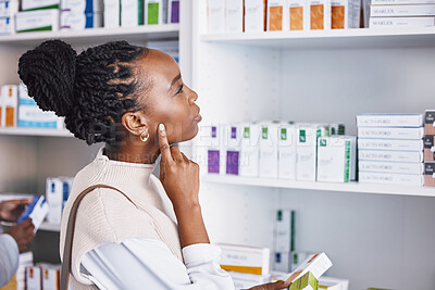 Buy stock photo Black woman, patient and thinking for healthcare drugs, medication decision for pain relief on pharmacy shelf. Thoughtful African female customer looking at pharmaceutical products for self diagnosis