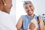 Happy, medical and a woman customer in a pharmacy for medicine, talking to a professional consultant. Smile, healthcare and a mature female patient chatting to a pharmacist in a clinic or dispensary