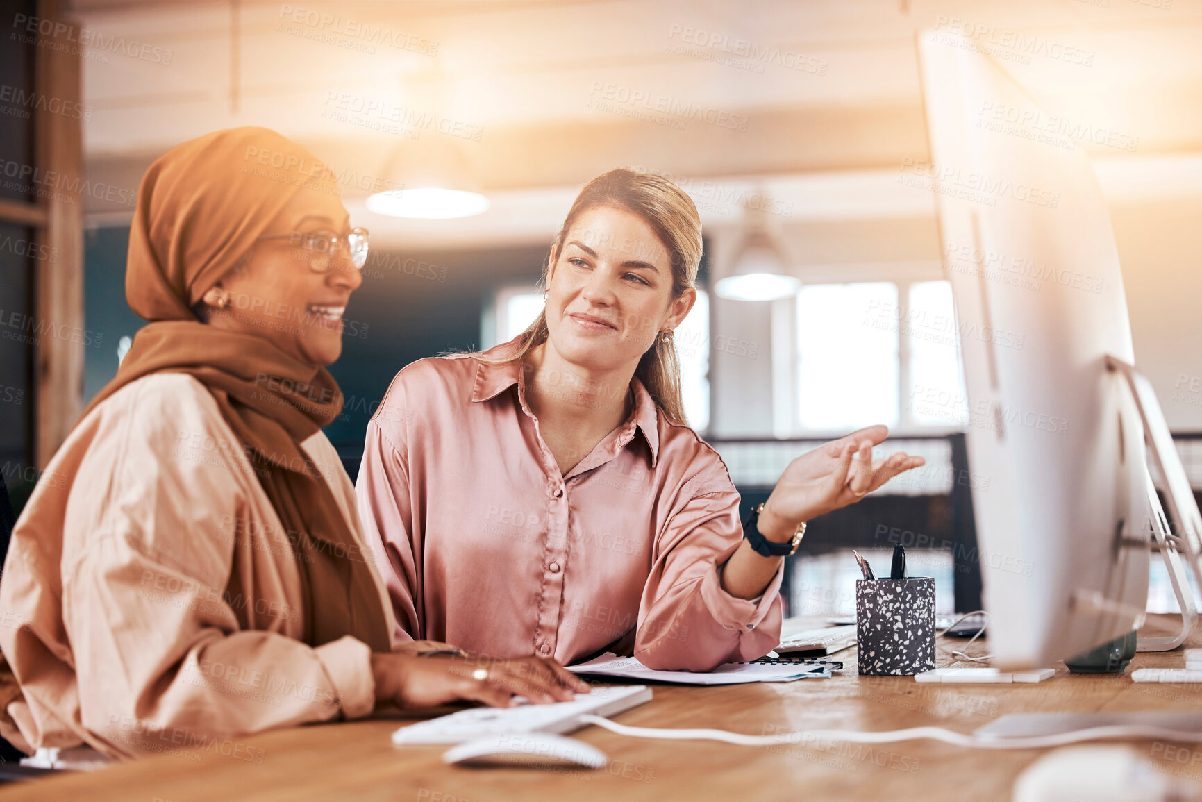 Buy stock photo Talking, women and training for business on a computer for advice, help and corporate collaboration. Happy, diversity and Muslim employee with a manager speaking, mentoring and helping with pc work