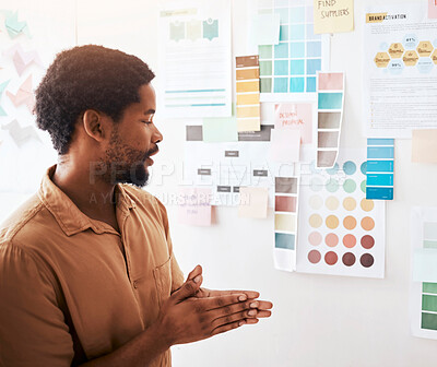 Buy stock photo Black man, color palette and planning in design, brainstorming or strategy on wall at office. Thoughtful Creative African male graphic designer looking at colors or ideas for project plan or startup