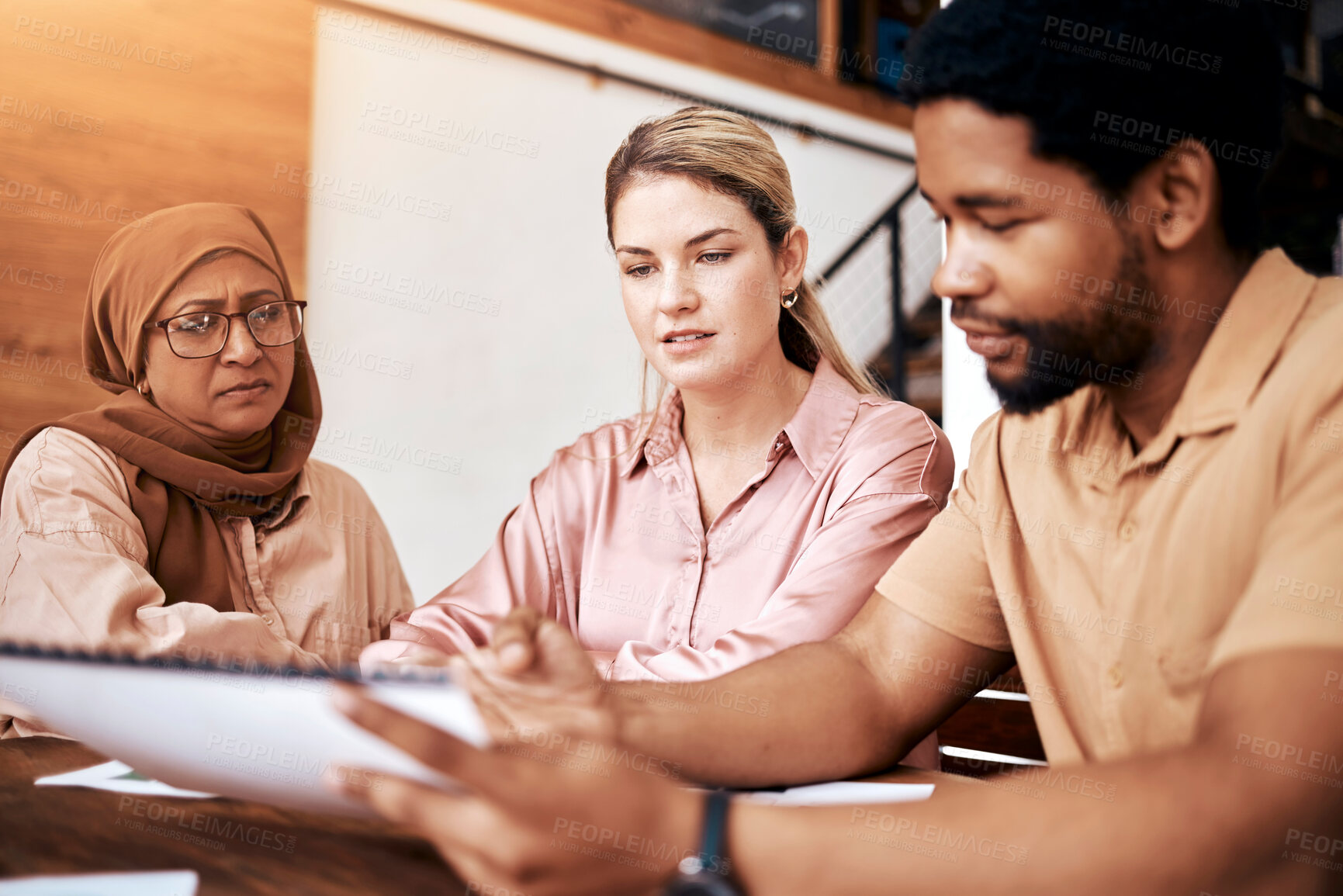 Buy stock photo Creative business people, meeting and documents in planning, collaboration or project design at the office. Group of employee designers discussing paperwork, strategy or ideas together for startup