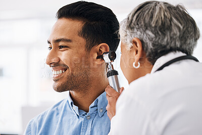 Buy stock photo Doctor check patient ear, healthcare and medical consultation at hospital with otolaryngology specialist. Happy man and physician woman with otoscope, test for hearing problem and health insurance