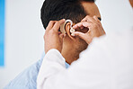 Doctor, man and hearing aid on ear for medical support, wellness and innovation of disability. Closeup, healthcare worker and deaf patient with audiology implant, service and help for sound waves 