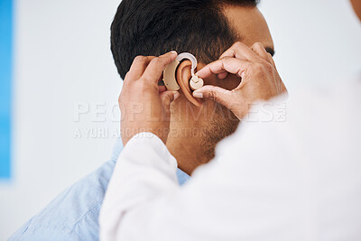 Buy stock photo Doctor, man and hearing aid on ear for medical support, wellness and innovation of disability. Closeup, healthcare worker and deaf patient with audiology implant, service and help for sound waves 